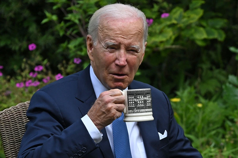 BRITAIN-US-DIPLOMACY
US President Joe Biden drinks from a 10 Downing Street-themed mug as he sits with Britain's Prime Minister Rishi Sunak in the garden of 10 Downing Street in central London on July 10, 2023, during their meeting. US President Joe Biden was in Britain on Monday for a brief visit to his key ally during which he met with Prime Minister Rishi Sunak before meeting King Charles III, and going on to a NATO summit in Lithuania. (Photo by ANDREW CABALLERO-REYNOLDS / AFP) (Photo by ANDREW CABALLERO-REYNOLDS/AFP via Getty Images)