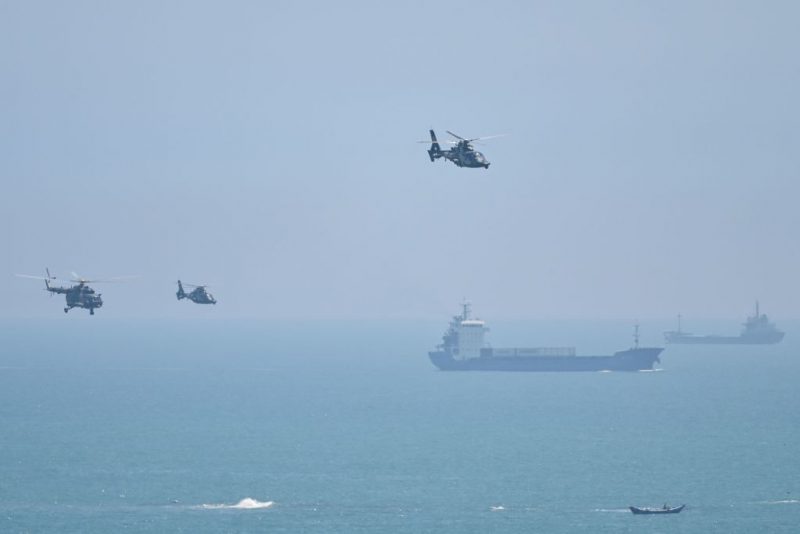 TOPSHOT - Chinese military helicopters fly past Pingtan island, one of mainland China's closest point from Taiwan, in Fujian province on August 4, 2022, ahead of massive military drills off Taiwan following US House Speaker Nancy Pelosi's visit to the self-ruled island. - China is due on August 4 to kick off its largest-ever military exercises encircling Taiwan, in a show of force straddling vital international shipping lanes following a visit to the self-ruled island by US House Speaker Nancy Pelosi. (Photo by Hector RETAMAL / AFP) (Photo by HECTOR RETAMAL/AFP via Getty Images)