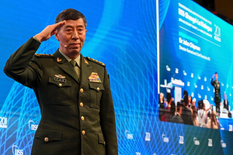 China's Minister of National Defence Li Shangfu salutes the audience before delivering a speech during the 20th Shangri-La Dialogue summit in Singapore on June 4, 2023. (Photo by Roslan RAHMAN / AFP) (Photo by ROSLAN RAHMAN/AFP via Getty Images)