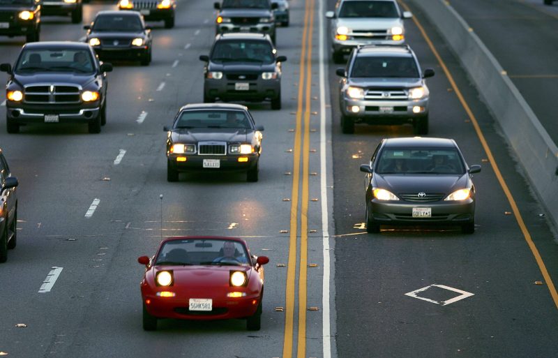 LOS ANGELES, CA - FEBRUARY 03: Cars drive in the High Occupancy Vehicle (HOV) lane (R), also called the diamond or commuter lane, on the 118 or Ronald Reagan Freeway on February 3, 2005 near Simi Valley, California. To encourage sales of environmentally-friendly hybrid cars, lawmakers are contemplating legislation that would allow states to determine whether to allow hybrid vehicles with no additional passengers to be driven in highway HOV lanes, currently reserved only for motorcycles and vehicles carrying multiple passengers. (Photo by David McNew/Getty Images)